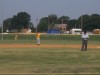 Bo McMinn with umpire Sarge awaits a pitch while Ty Wolfe looks on