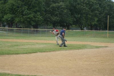 Jeff Seay starts his throw to first