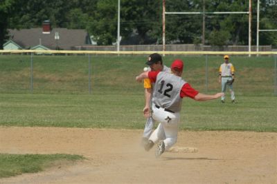 Ronny Carbo tries to block the ball as Rowe slides into 2nd